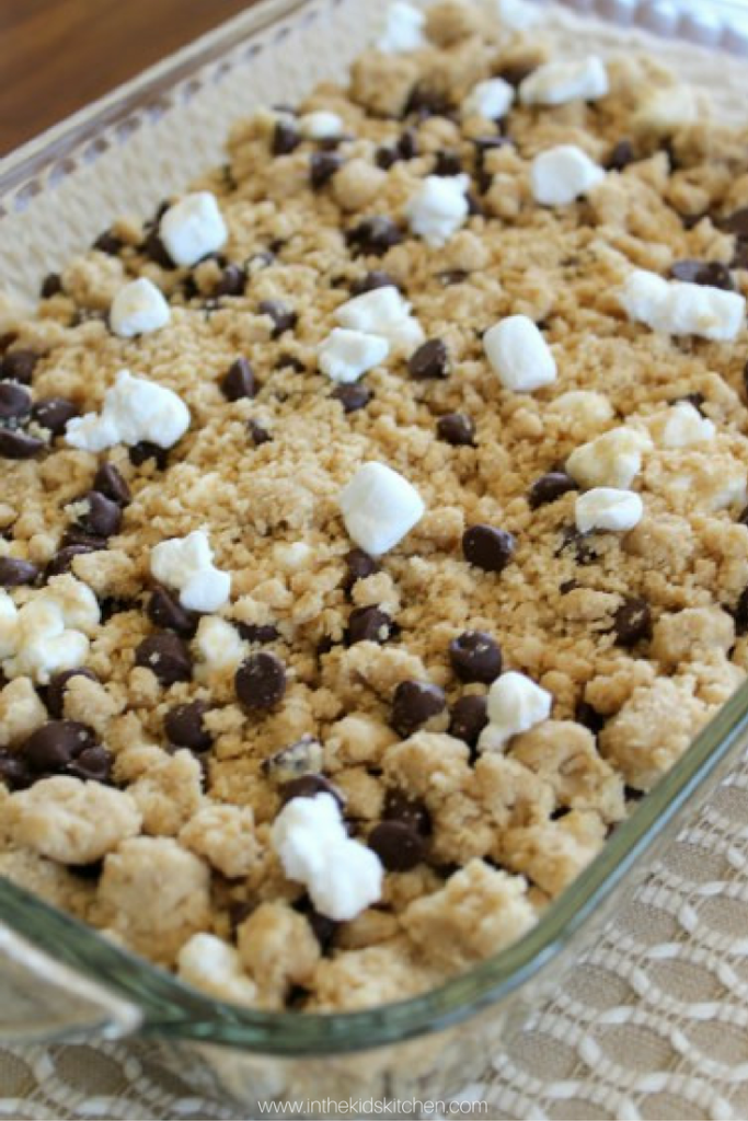 Ooey-Gooey melt-in-your-mouth S'mores Cookie Bars will be your new favorite treat! A perfect party dessert: easy to make & a chocolate-filled crowd pleaser!