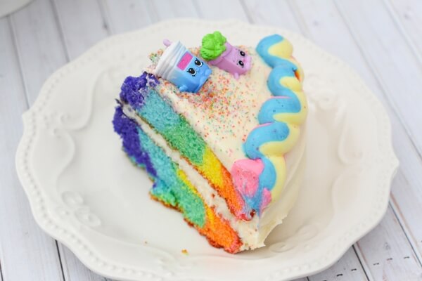 You'll never believe how easy it is to make this stunning Rainbow Shopkins Cake! Perfect for your favorite Shopkins fan or for a themed kids birthday party!