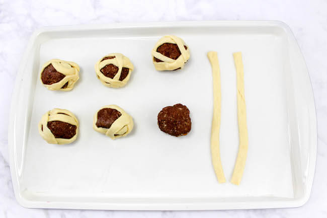 A non-candy Halloween treat that kids will love — Mummy Meatballs are a spooky fun party appetizer that's ready in about 20 minutes!