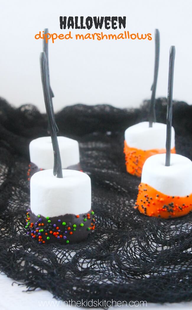 A quick & easy party treat that kids will love to make! These orange and black sprinkle Halloween Marshmallow Pops are spooky cute fun!