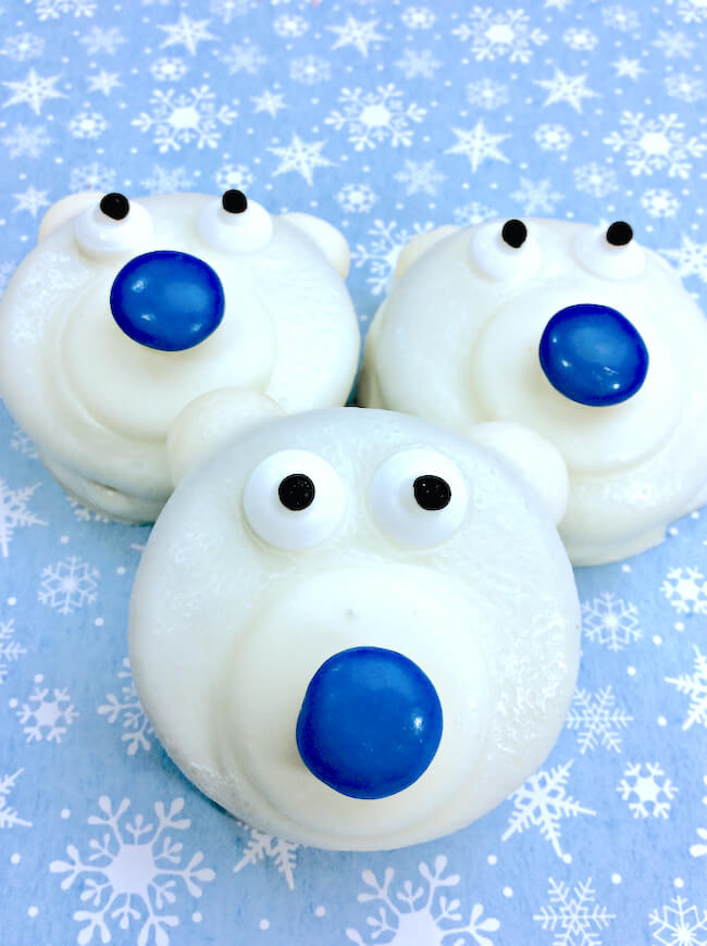Polar Bear Cookies are a frozen fun winter-themed kids treat or holiday party dessert! Easy chocolate dipped recipe to make with kids of all ages.