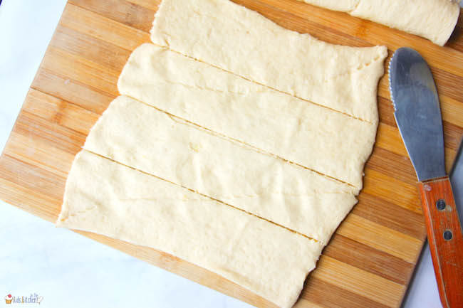 Strips of crescent dough on cutting board