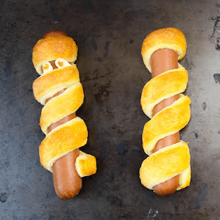 Easy and adorable Hot Dog Mummies are the perfect savory Halloween party appetizer! Ready in 15 minutes and only two ingredients required!