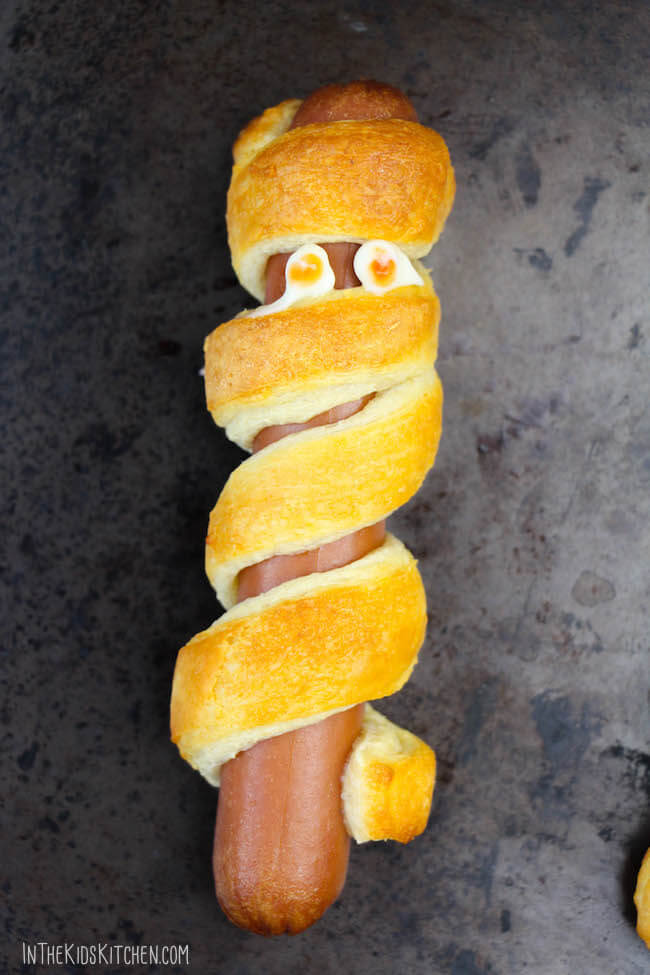 Easy and adorable Hot Dog Mummies are the perfect savory Halloween party appetizer! Ready in 15 minutes and only two ingredients required!
