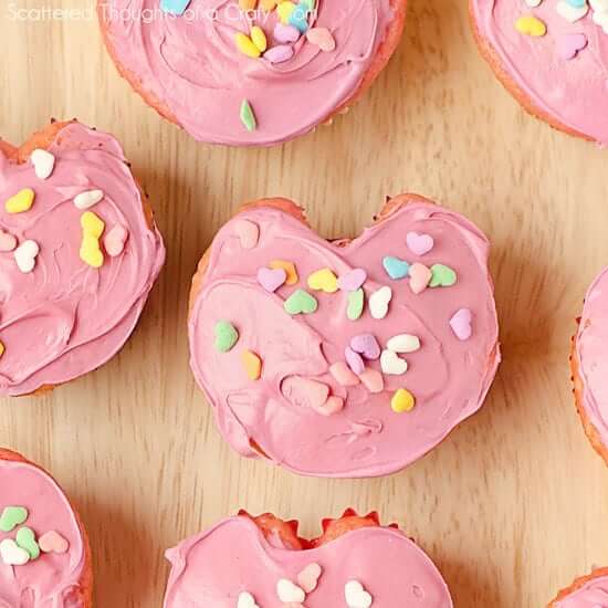 heart shaped pink frosted cupcakes.