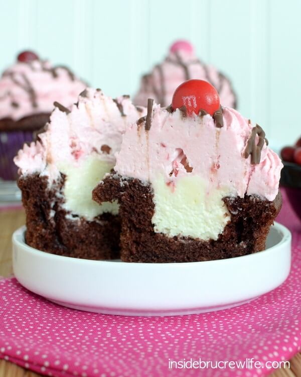 chocolate cupcakes with cream filling and pink frosting.