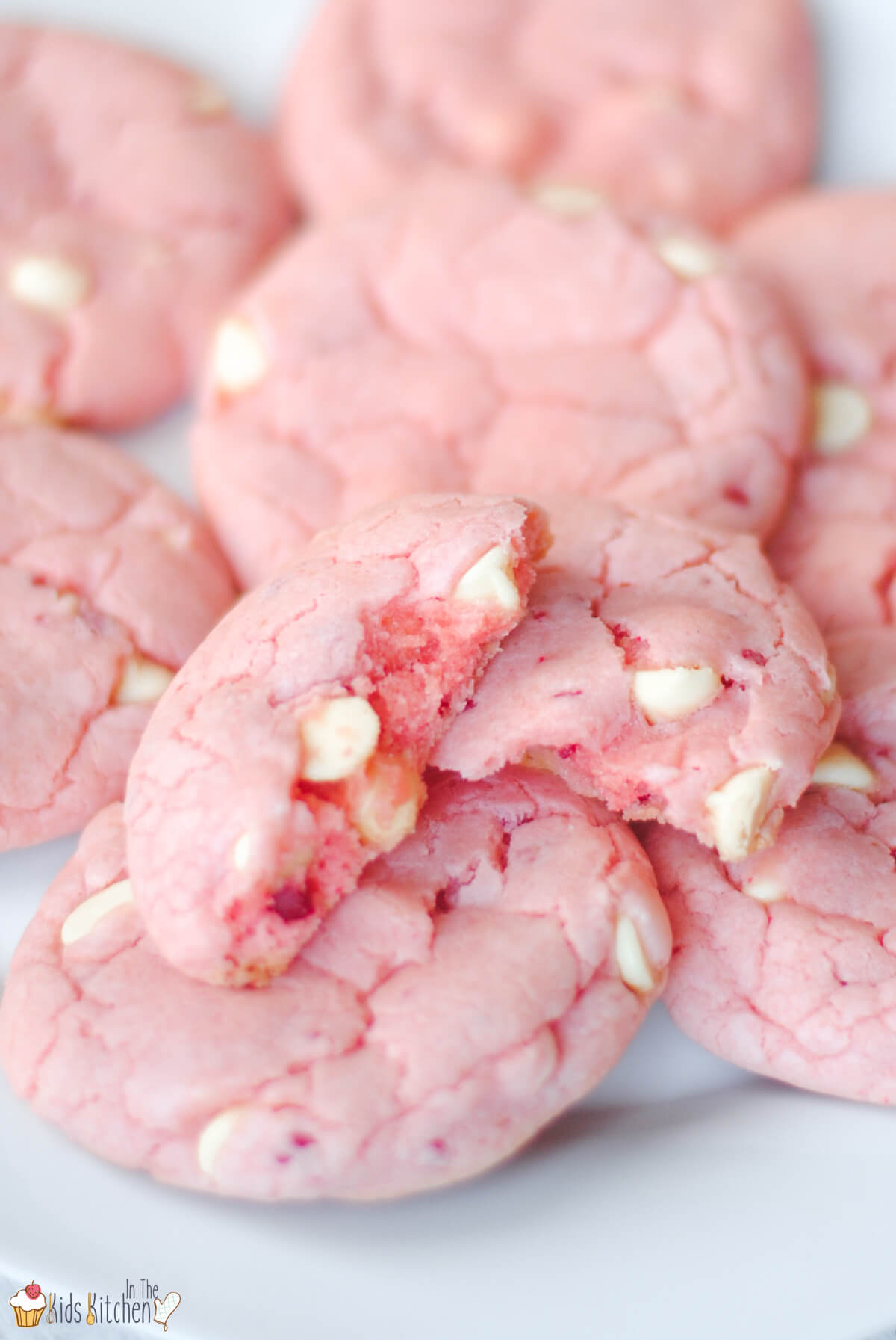 close up of a pile of strawberry cookies with white chocolate chips