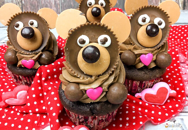 4 chocolate cupcakes decorated to look like teddy bears on top