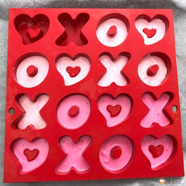 making valentine's day chocolate candy, using an X and O mold