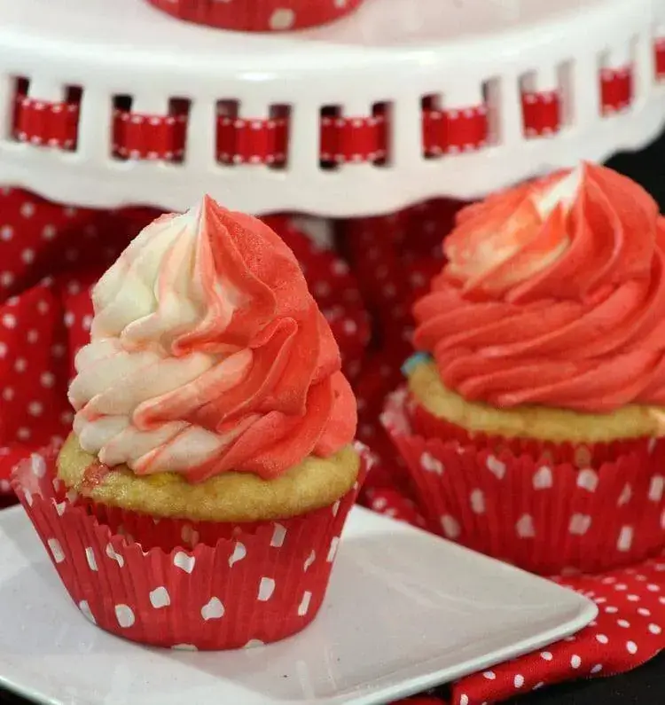 cupcakes with red and white swirled frosting.