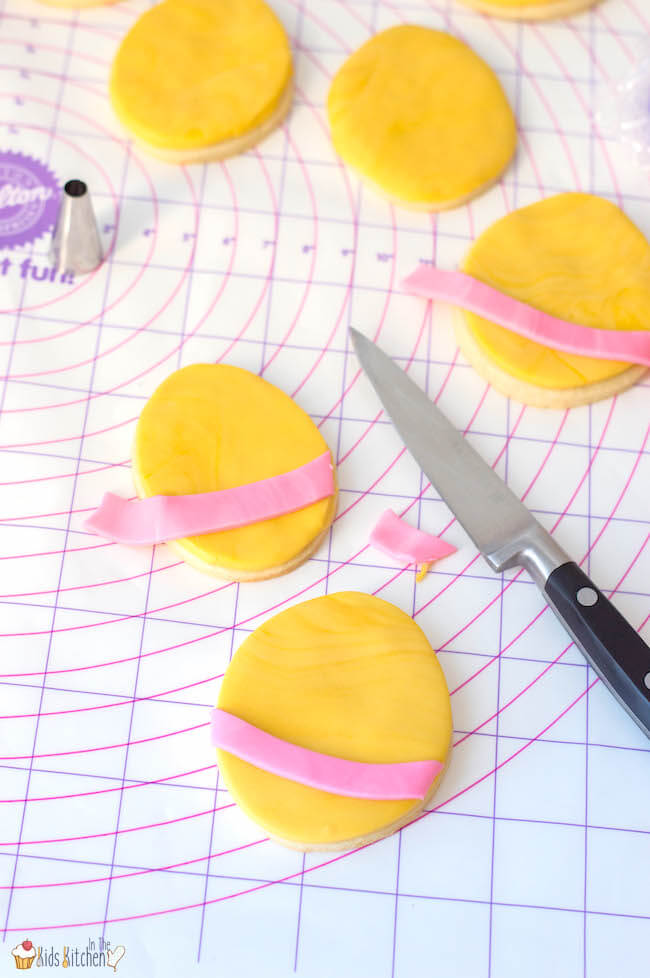 decorating Easter egg sugar cookies with pastel fondant