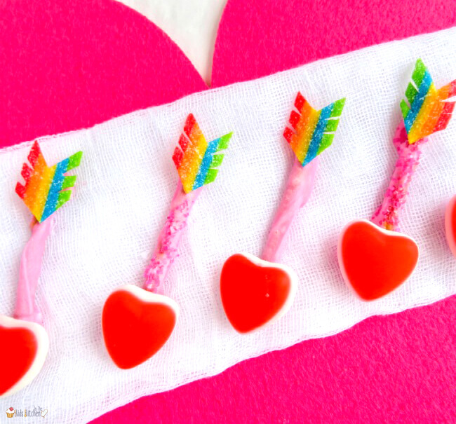 arrow pretzels with heart tip decorated to look like cupid's arrow