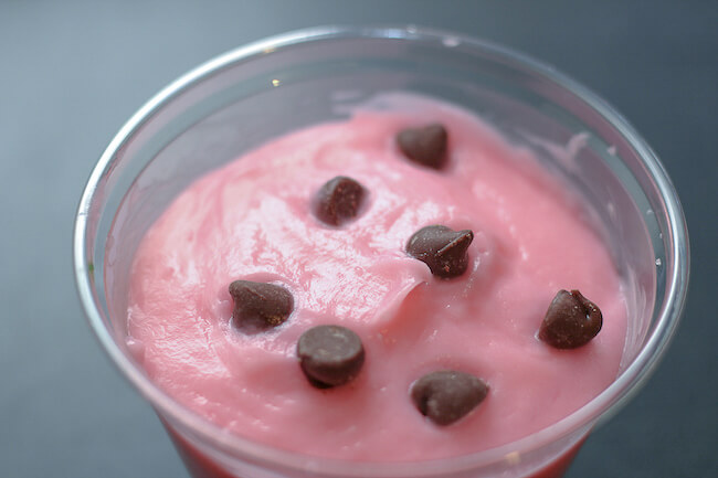 close up of pink pudding cup topped with chocolate chips