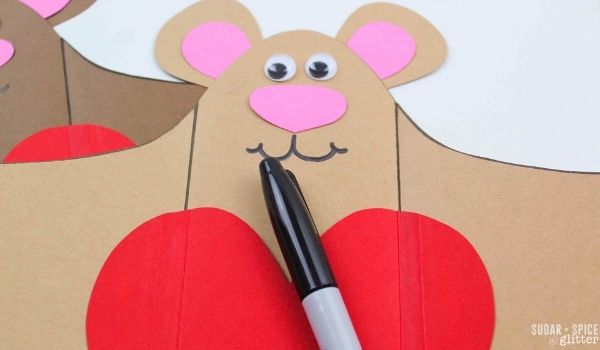 drawing a smile on a Valentine teddy bear craft