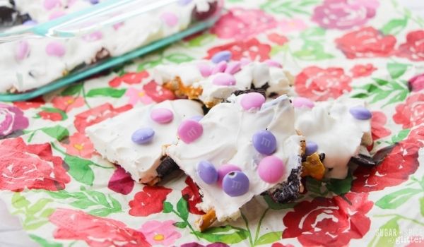 white chocolate pretzel bark pieces with pink and purple M&Ms