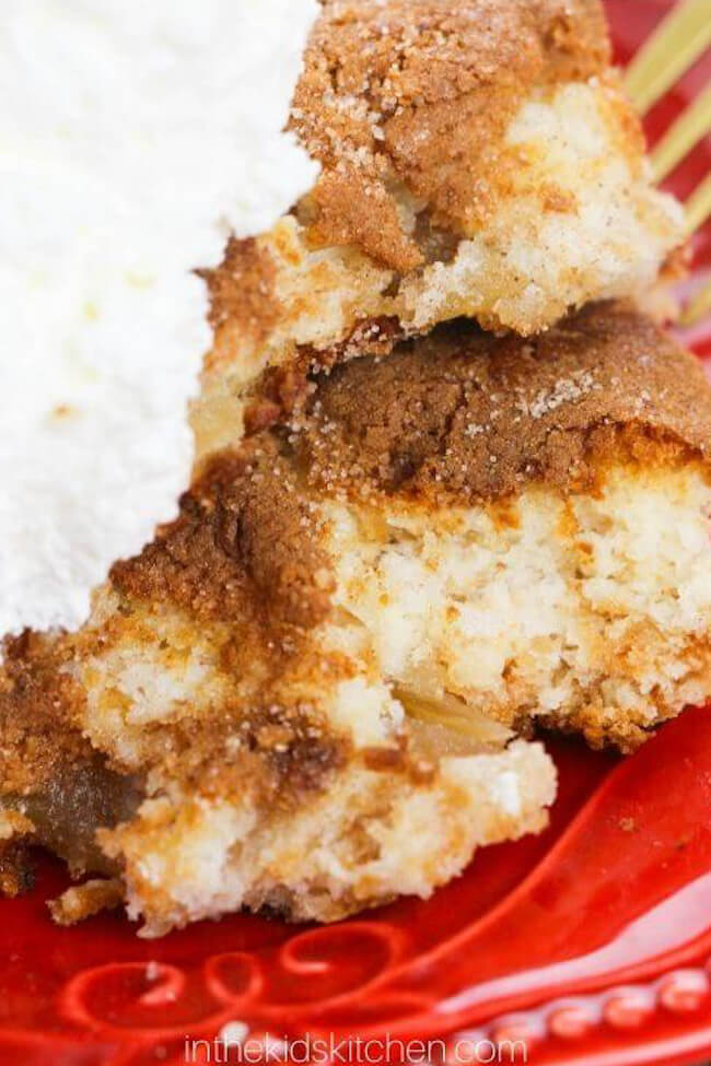 close up of an apple cake with whipped cream