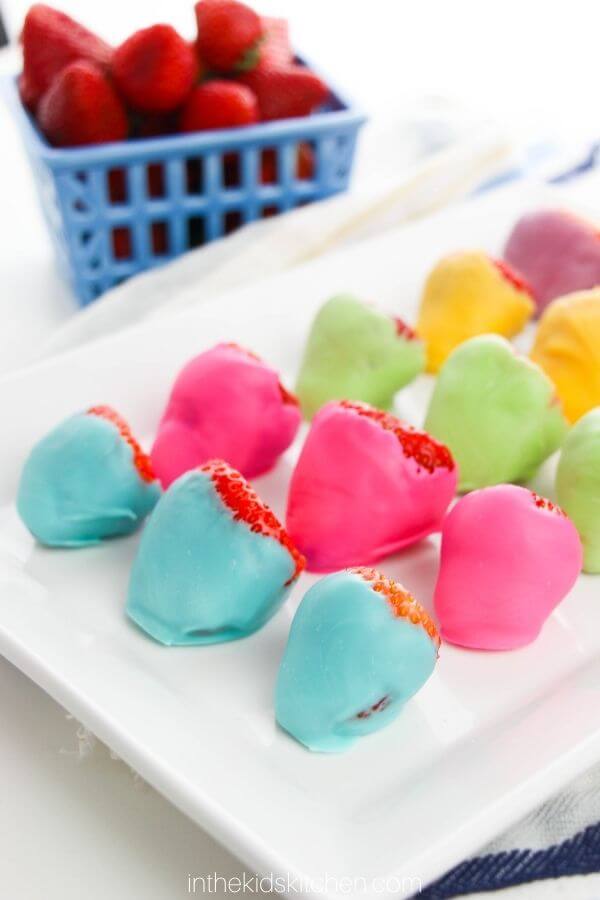 rainbow candy coated strawberries on plate
