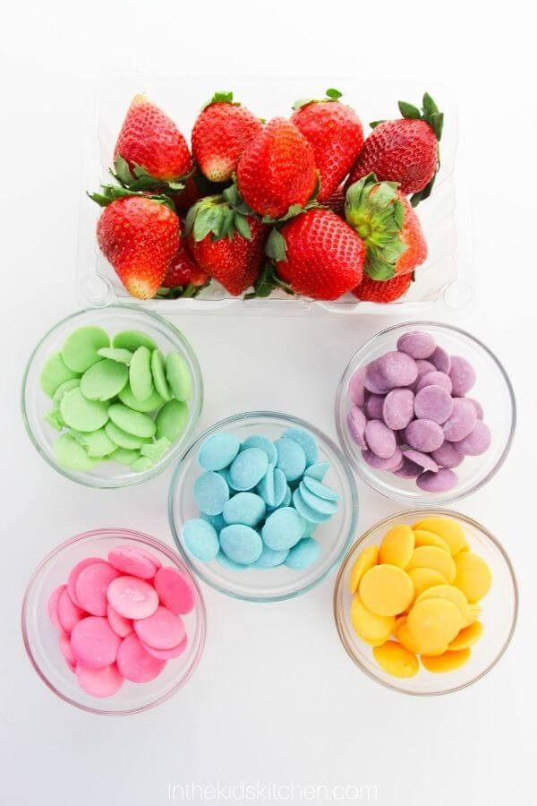 fresh strawberries and bowls of colorful candy melts