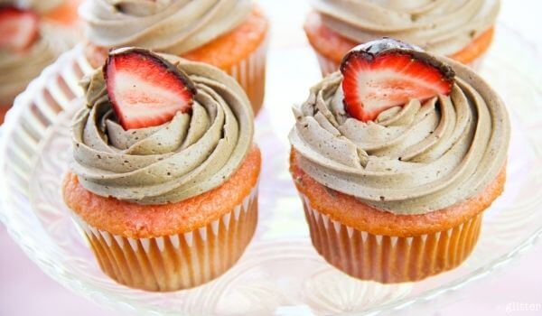 two chocolate covered strawberry cupcakes.