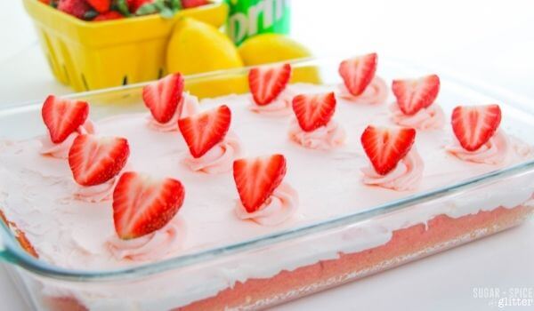 sheet cake topped with strawberries and icing