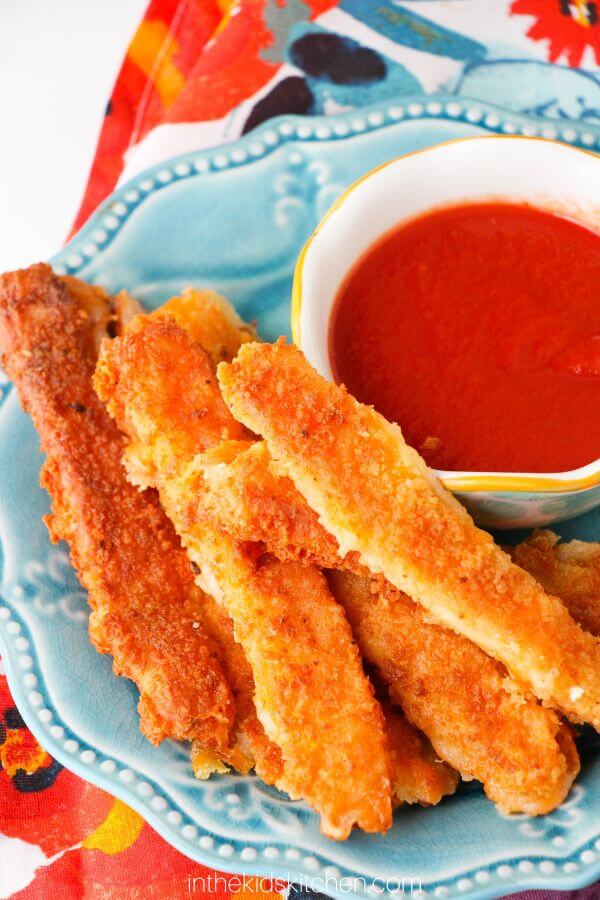 plate of homemade cheese sticks with marinara for dipping