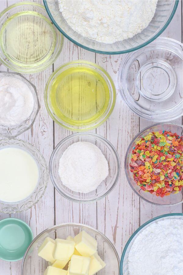 ingredients needed to make Fruity Pebbles cupcakes, in glass bowls