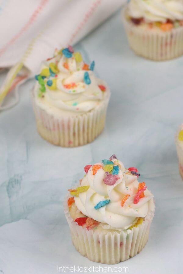 white cupcakes with Fruity Pebbles on top