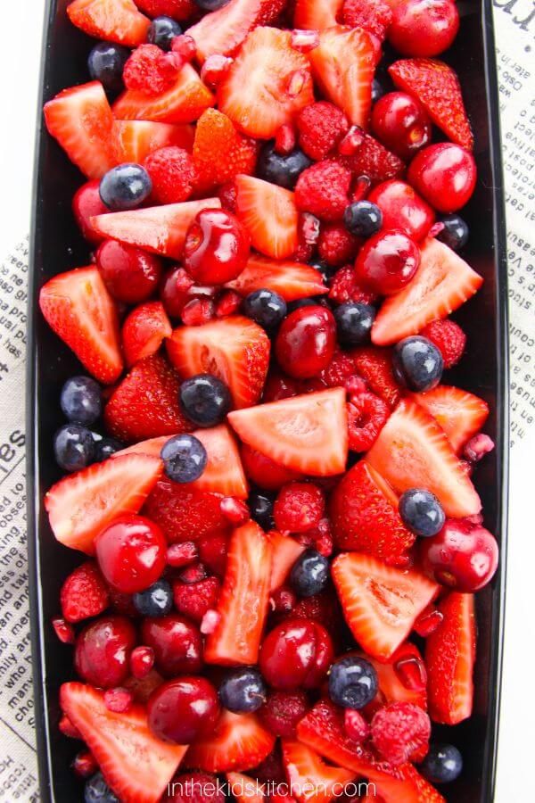 berry fruit salad with strawberries, blueberries, raspberries, and cherries.