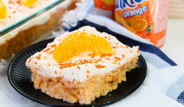 slice of orange cake with white icing