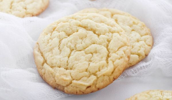 two sugar cookies on white cloth