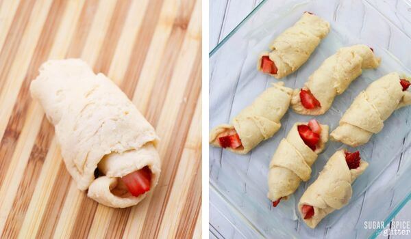 rolling up crescent dough triangles with strawberries inside