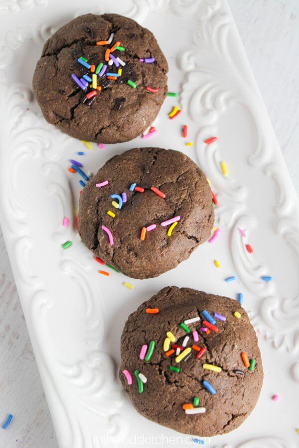chocolate cookies with sprinkles on a white plate