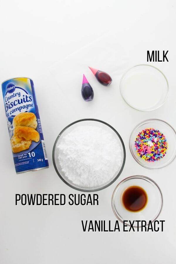 ingredients to make Unicorn Donuts, with text labels: milk, biscuits, powdered sugar, vanilla extract.