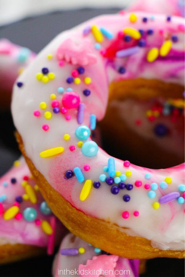 close up of unicorn donut glaze and sprinkles.