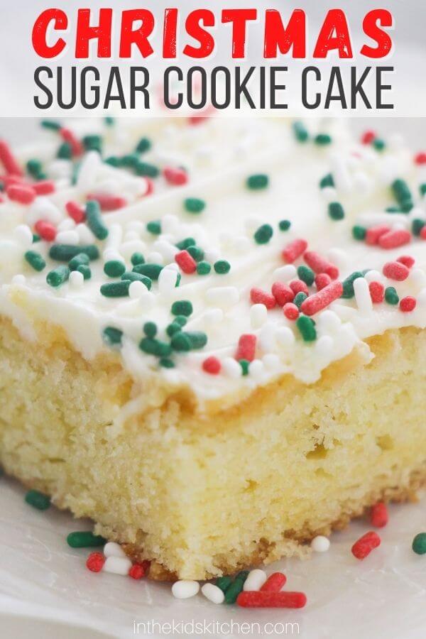 close up of a slice of sugar cookie sheet cake with frosting and red and green sprinkles; text overlay "Christmas Sugar Cookie Cake".