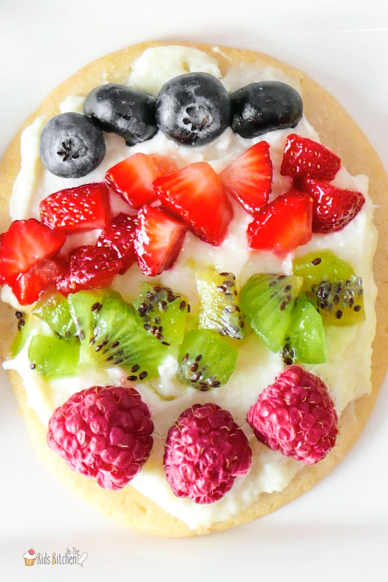 close up of a mini Easter egg fruit pizza made with a sugar cookie and fruit